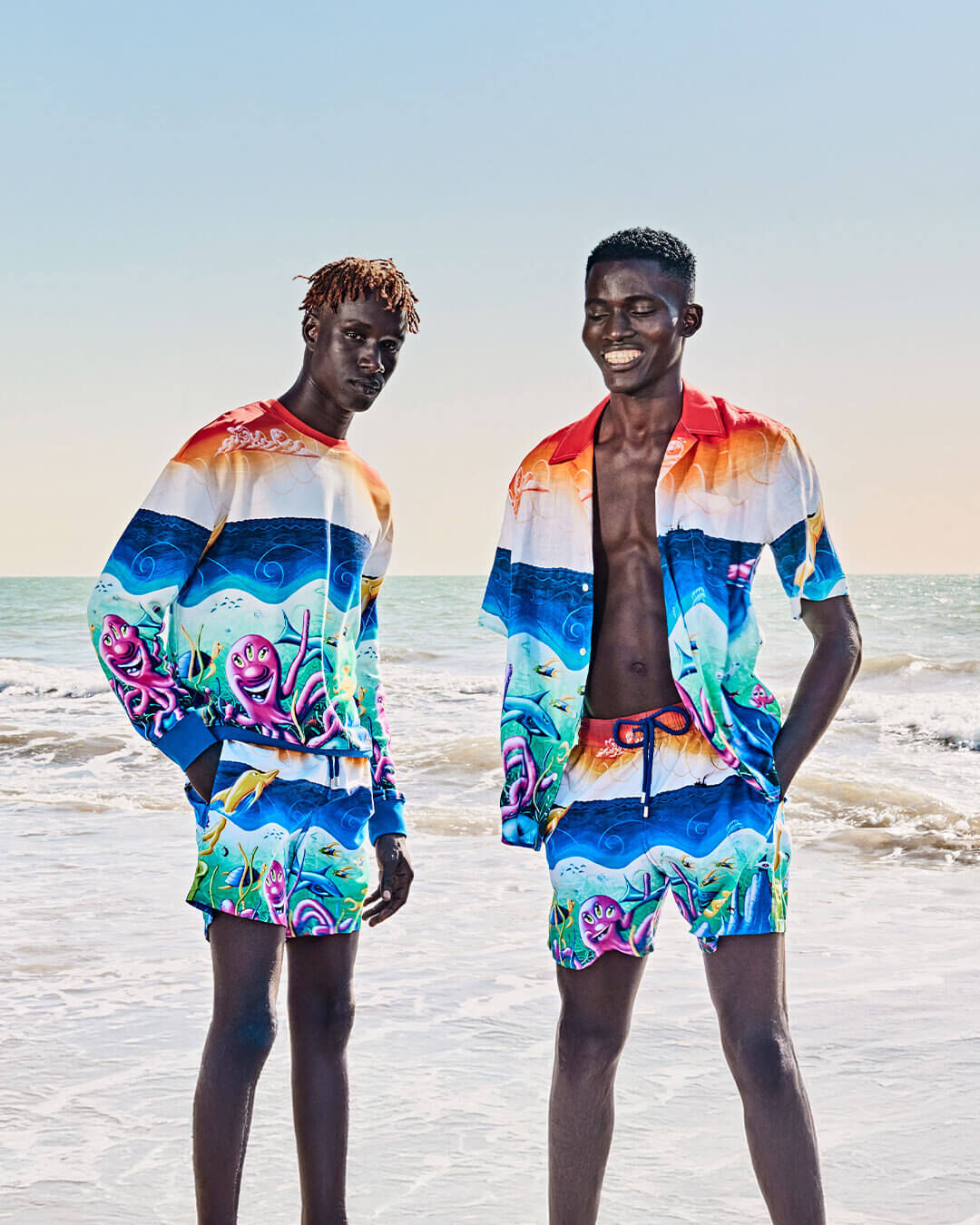 Two men on a beach wearing the Kenny Scharf Collaboration